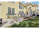 Outdoor patio and backyard area with a well-manicured lawn and exterior view of the tan home at 2909 Everson Ridge Ct, Snellville, GA 30039