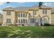 Green backyard featuring an outdoor seating area and a large two-story home with multiple windows at 2909 Everson Ridge Ct, Snellville, GA 30039