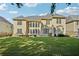 Lush backyard with manicured lawn, patio seating, and multi-story home with plenty of natural light at 2909 Everson Ridge Ct, Snellville, GA 30039