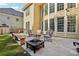 Backyard featuring a patio with seating, a fire pit, a well-maintained lawn, and a home exterior at 2909 Everson Ridge Ct, Snellville, GA 30039