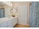Bright bathroom featuring a white vanity, decorative artwork, and stylish shower curtain at 2909 Everson Ridge Ct, Snellville, GA 30039