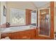 Bathroom features a luxurious soaking tub and a separate shower with decorative glass at 2909 Everson Ridge Ct, Snellville, GA 30039