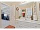 Bright bathroom with white cabinets, spacious countertop, and a view into an adjacent living space at 2909 Everson Ridge Ct, Snellville, GA 30039
