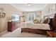Inviting bedroom features natural light, neutral colors, a dresser and a TV at 2909 Everson Ridge Ct, Snellville, GA 30039