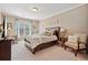 Cozy bedroom featuring neutral tones, natural light, and a comfortable seating area at 2909 Everson Ridge Ct, Snellville, GA 30039