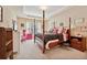 Charming bedroom with four-poster bed, bright accents, and ample natural light at 2909 Everson Ridge Ct, Snellville, GA 30039