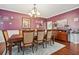 A formal dining area showcases rich colors, hardwood floors, and an elegant chandelier at 2909 Everson Ridge Ct, Snellville, GA 30039