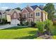 Attractive brick and siding home with a manicured front lawn and mature landscaping at 2909 Everson Ridge Ct, Snellville, GA 30039