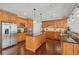 Modern kitchen with stainless steel appliances, an island, and wooden cabinetry at 2909 Everson Ridge Ct, Snellville, GA 30039