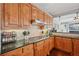 Well-lit kitchen features granite countertops, gas cooktop, and warm wood cabinetry at 2909 Everson Ridge Ct, Snellville, GA 30039