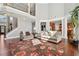 Bright living room featuring hardwood floors, soaring ceilings, and a cozy seating arrangement near the kitchen at 2909 Everson Ridge Ct, Snellville, GA 30039