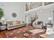 Open-concept living room featuring hardwood floors, soaring ceilings, and a cozy seating arrangement at 2909 Everson Ridge Ct, Snellville, GA 30039
