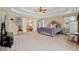 Spacious main bedroom with a ceiling fan, lounge area, and ensuite access at 2909 Everson Ridge Ct, Snellville, GA 30039