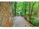 A simple patio abuts a lush backyard, offering a serene outdoor escape and privacy at 3294 Francine Dr, Decatur, GA 30033
