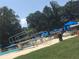 Community pool featuring lounge chairs with blue umbrellas and a diving board at 3294 Francine Dr, Decatur, GA 30033