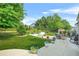 Expansive backyard with patio, lush lawn, mature trees, and comfortable outdoor seating at 60 Heaton Dr, Covington, GA 30016
