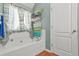 Bright bathroom featuring a bathtub with curtains and a towel rack at 60 Heaton Dr, Covington, GA 30016