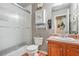 Bathroom featuring a glass-door shower, a wooden vanity, and gray walls at 60 Heaton Dr, Covington, GA 30016