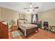 Cozy bedroom with a ceiling fan, bed, nightstand, and patterned bedding at 60 Heaton Dr, Covington, GA 30016