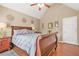 Cozy bedroom featuring a wooden sleigh bed, a ceiling fan, and warm, neutral wall tones at 60 Heaton Dr, Covington, GA 30016