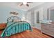 Bedroom with wood floors, a ceiling fan, and sky blue walls at 60 Heaton Dr, Covington, GA 30016