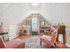Comfortable bonus room with vaulted ceiling and hardwood floors provides a perfect space for relaxing at 60 Heaton Dr, Covington, GA 30016