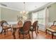 Elegant dining room with hardwood floors, a chandelier, and comfortable seating for formal meals at 60 Heaton Dr, Covington, GA 30016