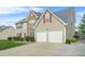 Two-story home with stone facade and a two-car garage, complemented by a lush green lawn at 60 Heaton Dr, Covington, GA 30016