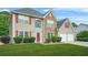 Charming two-story home featuring a well-manicured lawn and a welcoming red front door at 60 Heaton Dr, Covington, GA 30016