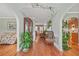 Inviting hallway featuring hardwood floors, decorative plants, and a view into the adjacent living spaces at 60 Heaton Dr, Covington, GA 30016