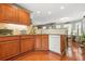 Bright kitchen with wood cabinets and granite countertops opens to the breakfast area at 60 Heaton Dr, Covington, GA 30016