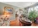 Warm living area with hardwood floors, decorative plants, and an archway leading to other rooms at 60 Heaton Dr, Covington, GA 30016