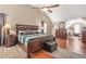 Large main bedroom features vaulted ceilings, wood floors, and a king-sized bed with ensuite bathroom at 60 Heaton Dr, Covington, GA 30016
