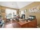 Home office with vaulted ceilings, lots of natural light, and a large wooden desk at 60 Heaton Dr, Covington, GA 30016