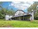 Home exterior displaying a deck and backyard, as well as stairwell leading to the ground at 8464 Pleasant Hill Rd, Lithonia, GA 30058