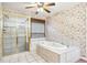 Bathroom with floral wallpaper with glass shower and large tub at 8464 Pleasant Hill Rd, Lithonia, GA 30058