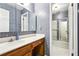 Bathroom with patterned wallpaper, vanity and mirror, and shower/tub combo at 8464 Pleasant Hill Rd, Lithonia, GA 30058