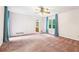 Open bedroom featuring a ceiling fan and a view to the bathroom at 8464 Pleasant Hill Rd, Lithonia, GA 30058