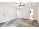 Spacious bedroom featuring neutral carpeting, a ceiling fan, and ample natural light at 8464 Pleasant Hill Rd, Lithonia, GA 30058