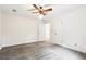 Bright bedroom featuring a ceiling fan, neutral walls, and multiple entry points at 8464 Pleasant Hill Rd, Lithonia, GA 30058