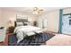 Staged bedroom featuring a large bed, neutral walls, and a sliding glass door to the outside deck at 8464 Pleasant Hill Rd, Lithonia, GA 30058