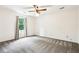 Neutral bedroom showcasing a ceiling fan and a window, offering ample natural light at 8464 Pleasant Hill Rd, Lithonia, GA 30058