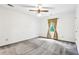 White bedroom with a ceiling fan and a large window at 8464 Pleasant Hill Rd, Lithonia, GA 30058