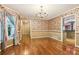 Dining room featuring hardwood floors, floral wallpaper and view of the kitchen at 8464 Pleasant Hill Rd, Lithonia, GA 30058