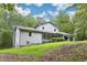 A charming home with a manicured lawn, lush green trees, and a welcoming facade at 8464 Pleasant Hill Rd, Lithonia, GA 30058