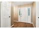 A welcoming foyer featuring gleaming hardwood floors and a classic white front door with sidelights at 8464 Pleasant Hill Rd, Lithonia, GA 30058