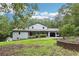 Charming home featuring a covered front porch, attached garage, and beautifully landscaped front yard at 8464 Pleasant Hill Rd, Lithonia, GA 30058