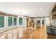 Open kitchen and dining area featuring hardwood floors, large windows and granite countertops at 8464 Pleasant Hill Rd, Lithonia, GA 30058