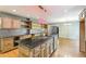 Bright kitchen featuring wood cabinets, granite countertops, a center island, and stainless steel appliances at 8464 Pleasant Hill Rd, Lithonia, GA 30058