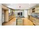 Spacious kitchen with a center island, modern appliances, wood cabinets, and granite countertops at 8464 Pleasant Hill Rd, Lithonia, GA 30058